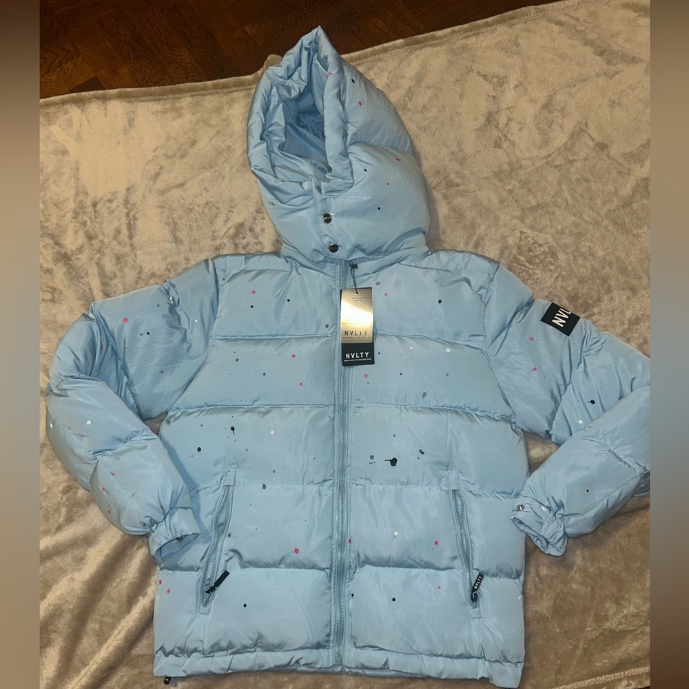NVLTY Puffer Jacket
Medium 
Baby Blue with Paint design